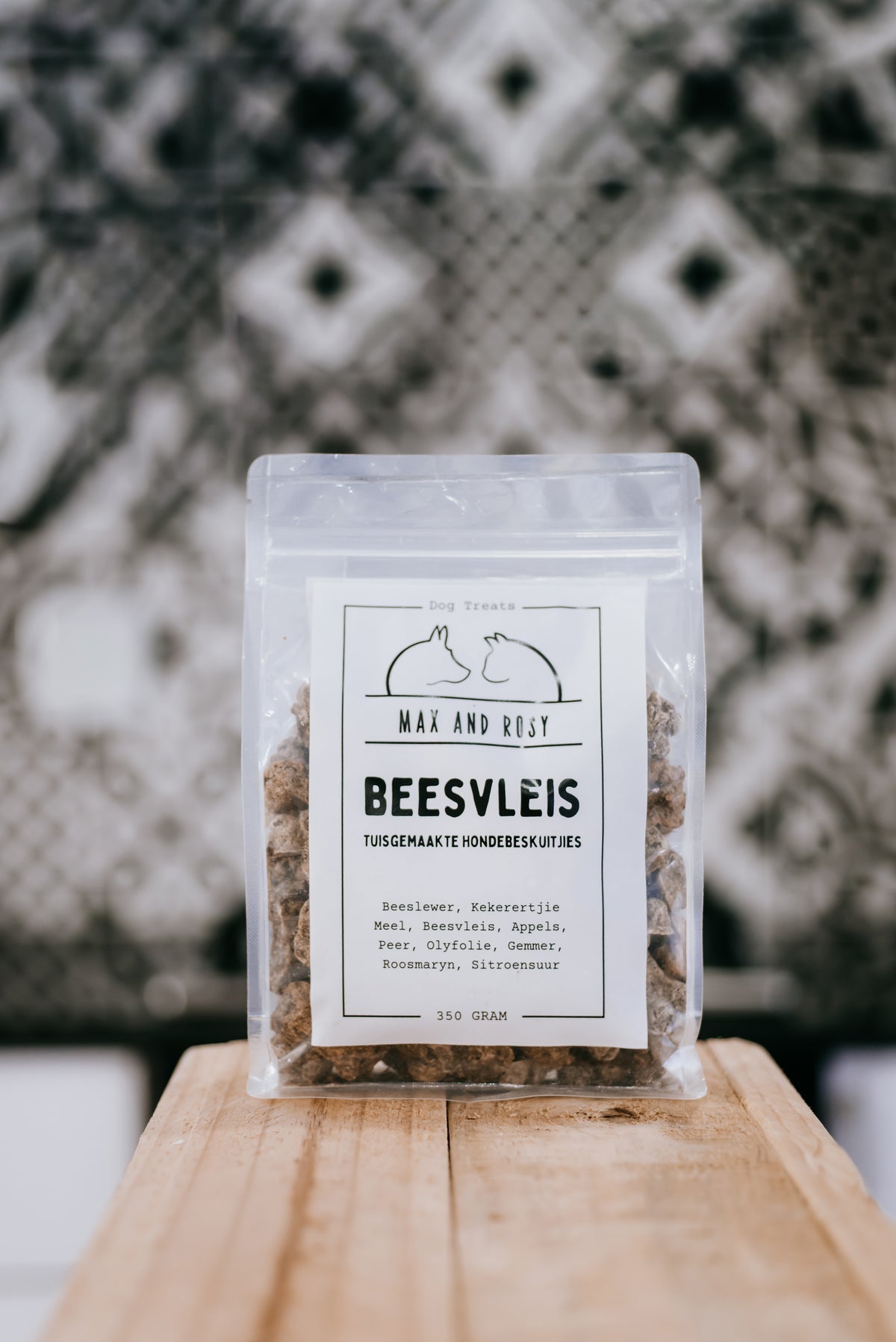 Max and Rosy beef dog treats pouch on a wooden board